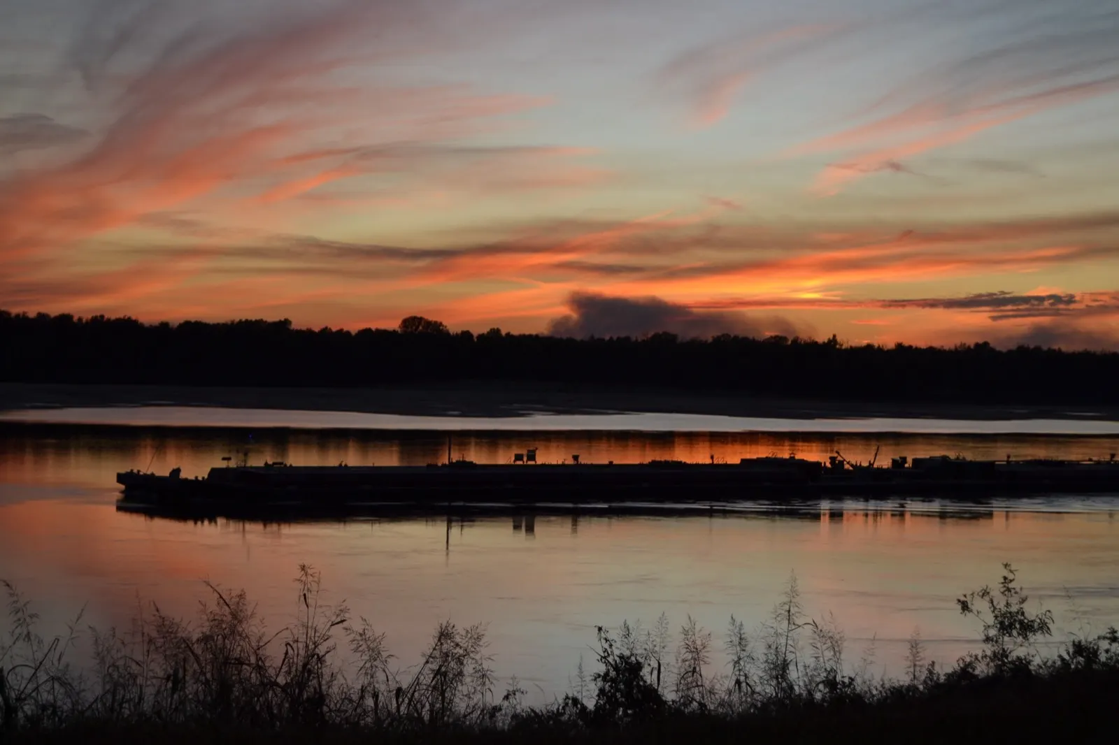 A barge passing on the river at dusk