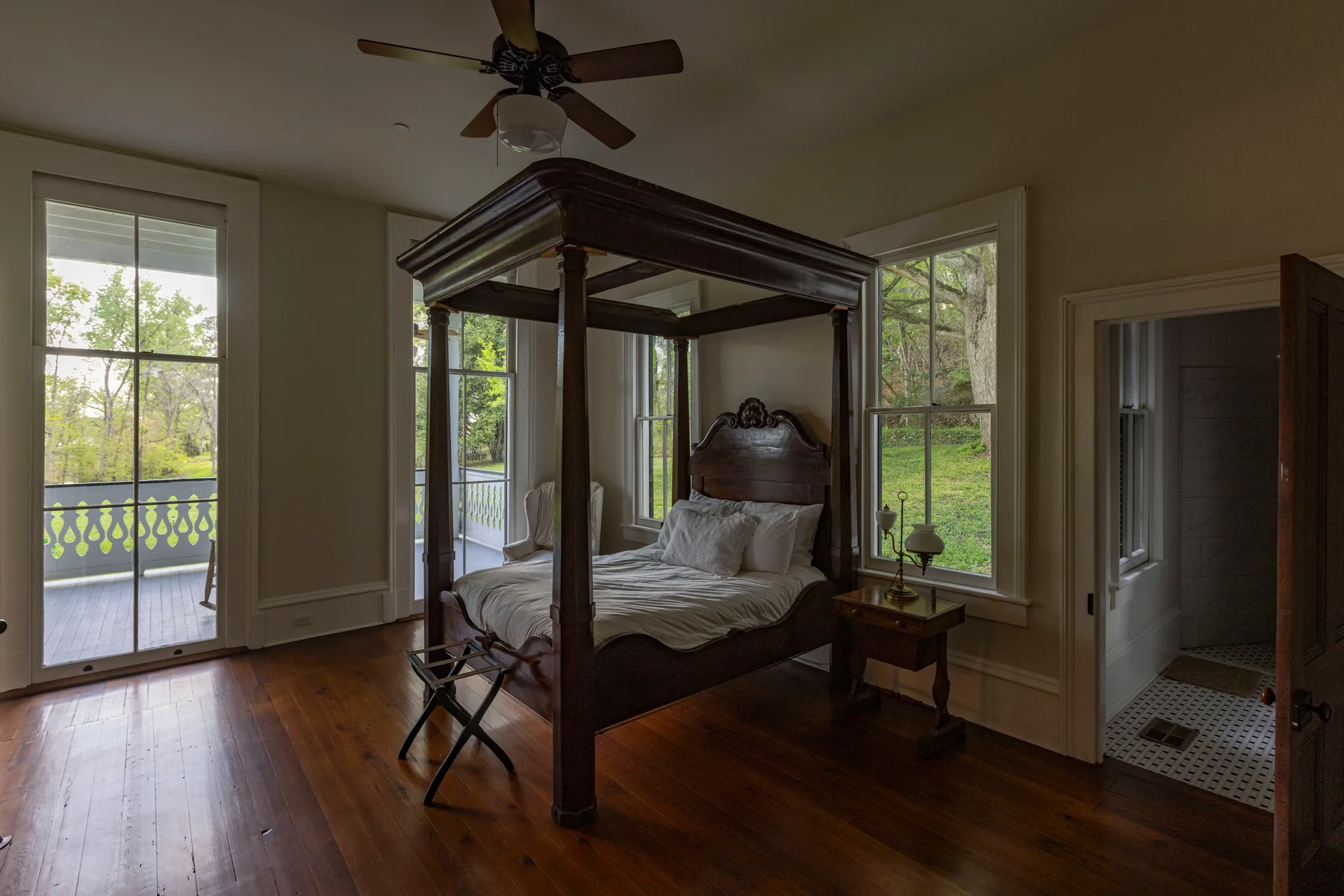 A guest bedroom in the home with a carved four-poster bed