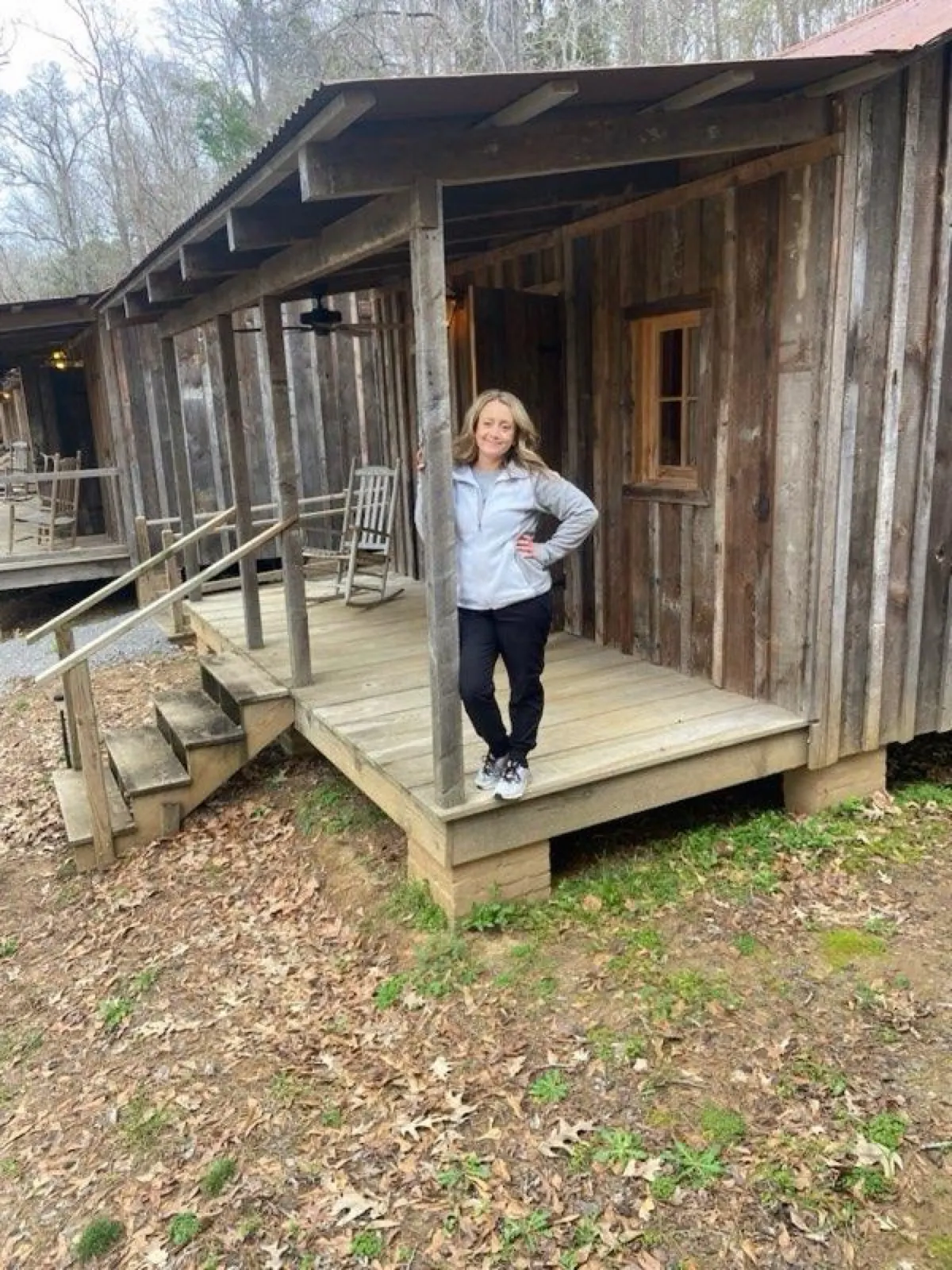 On the porch of a rustic guest cabin