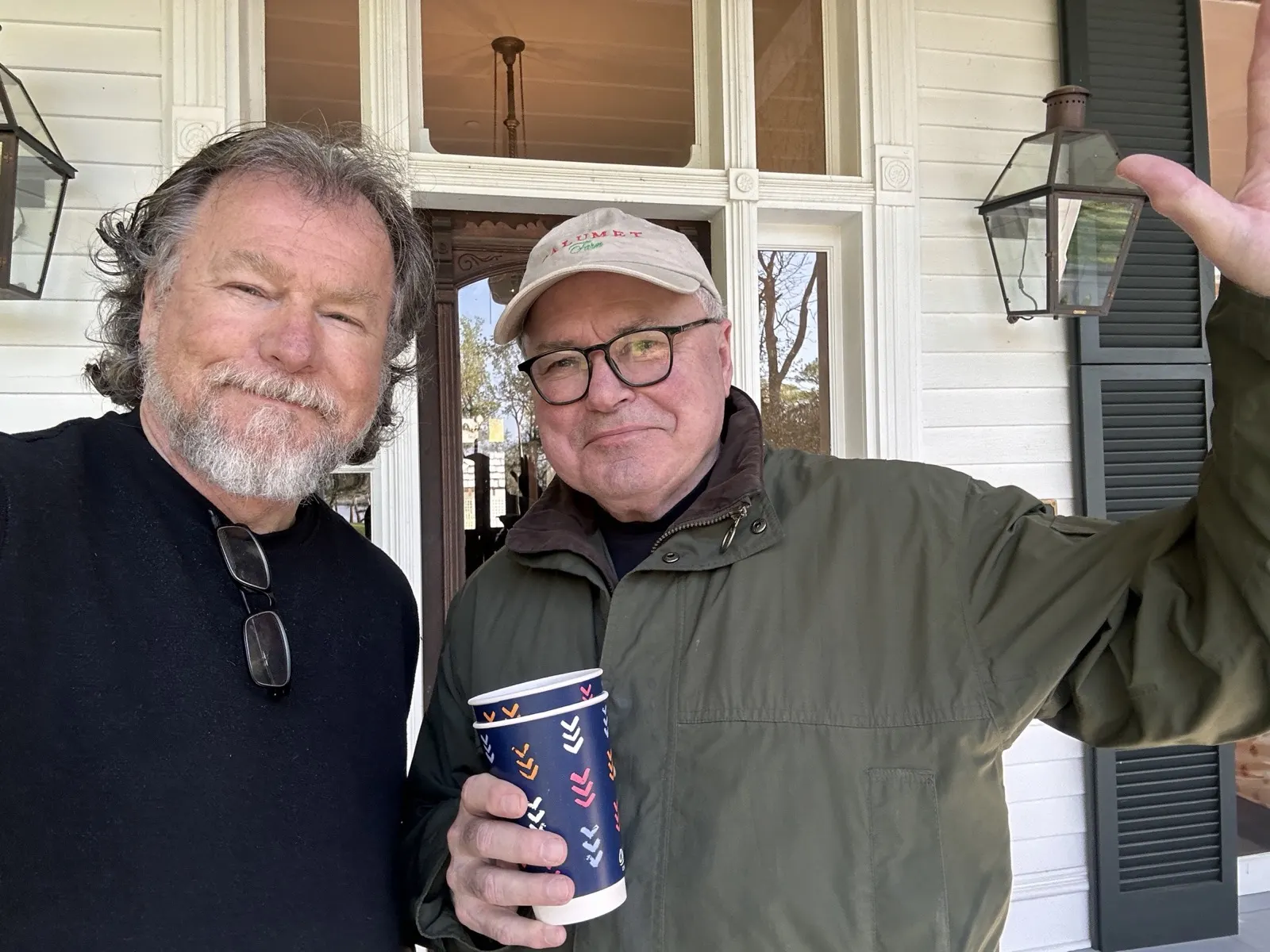 Two friends on the front porch of the home