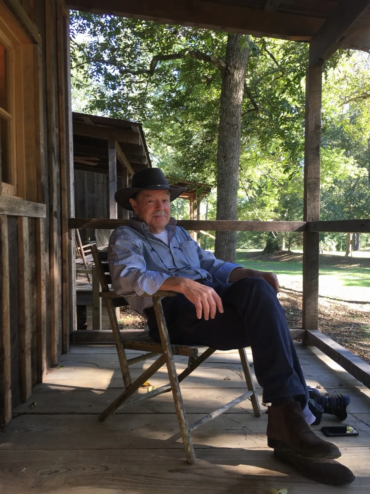 A guest at rest on a cabin porch
