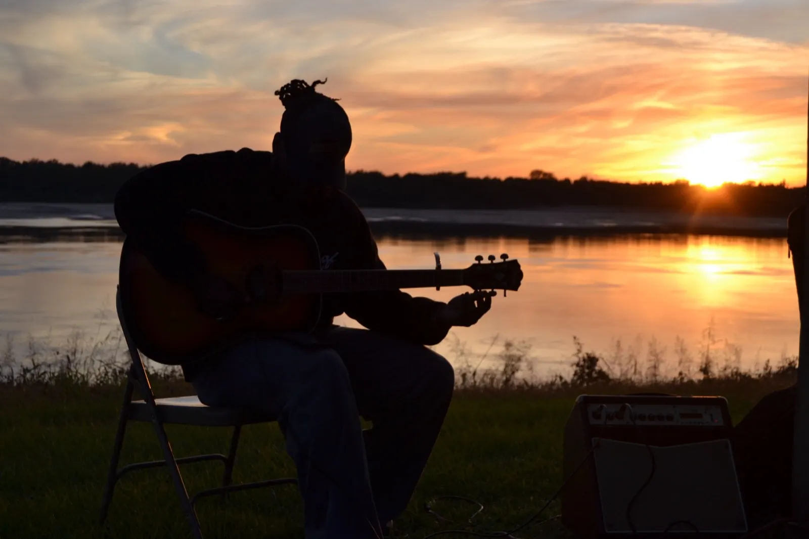 Music on the riverbank at sunset