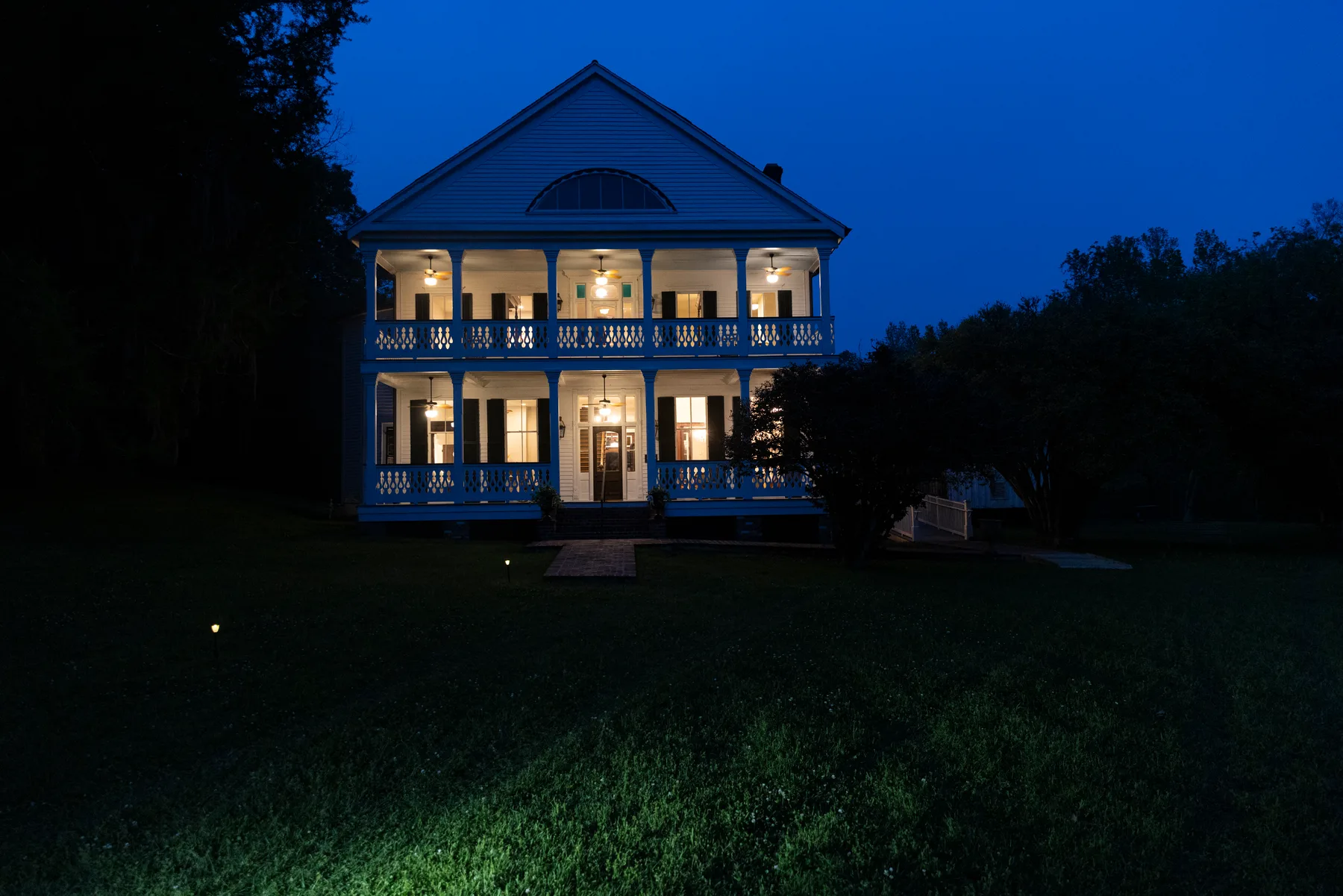 The home lit from within at dusk