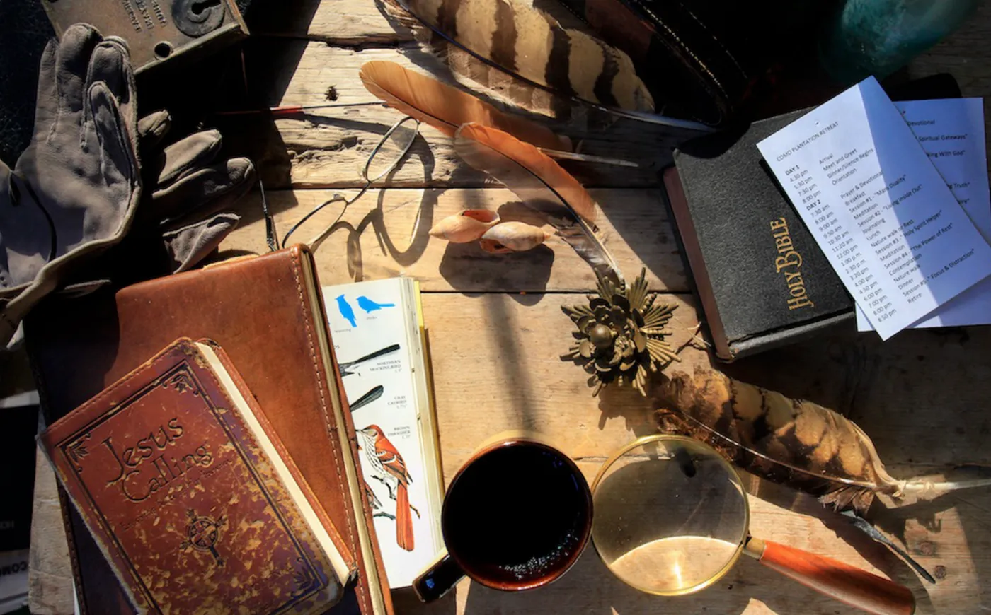 A journal, coffee and books left on a desk