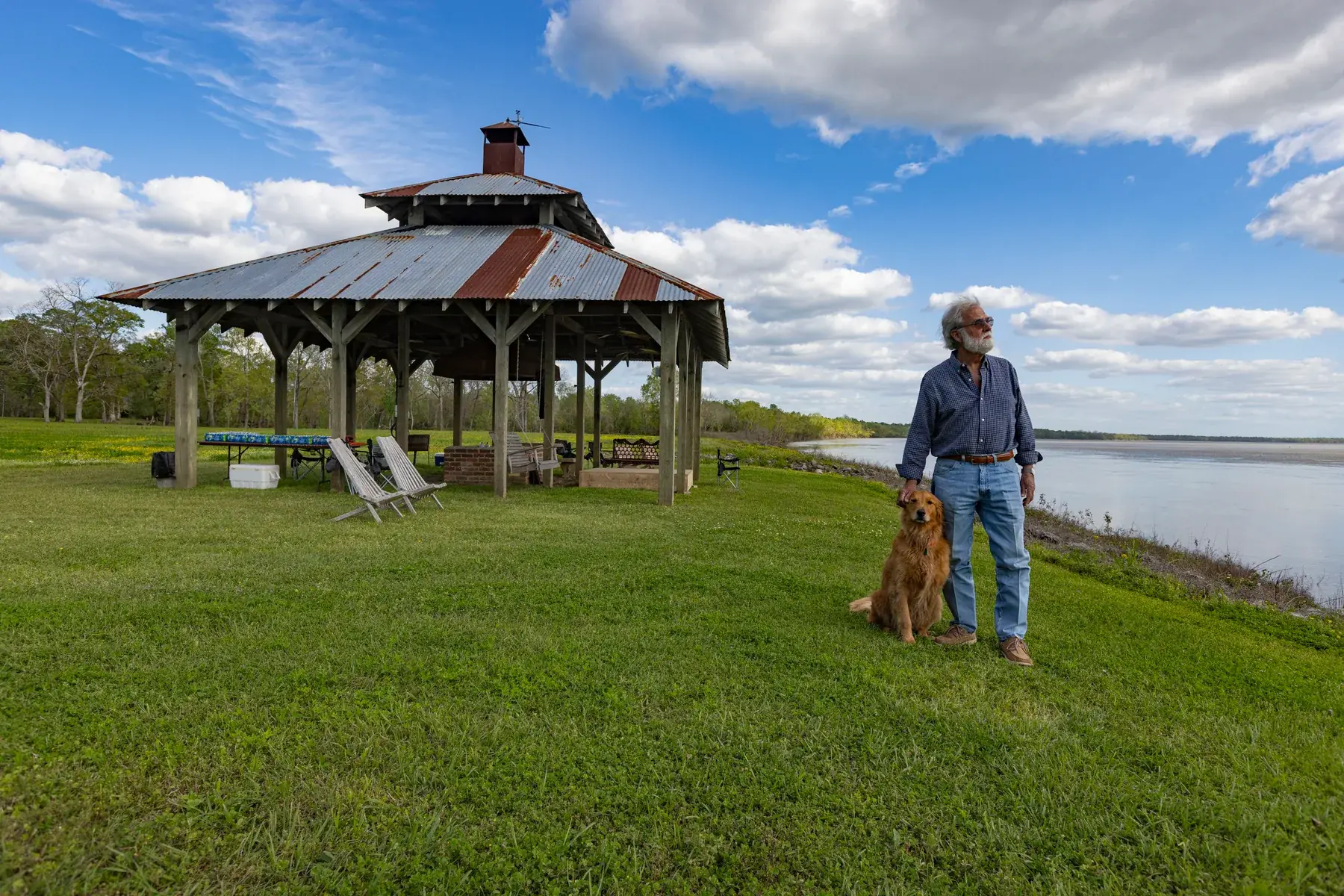 A man with his dog at the blacksmith shop