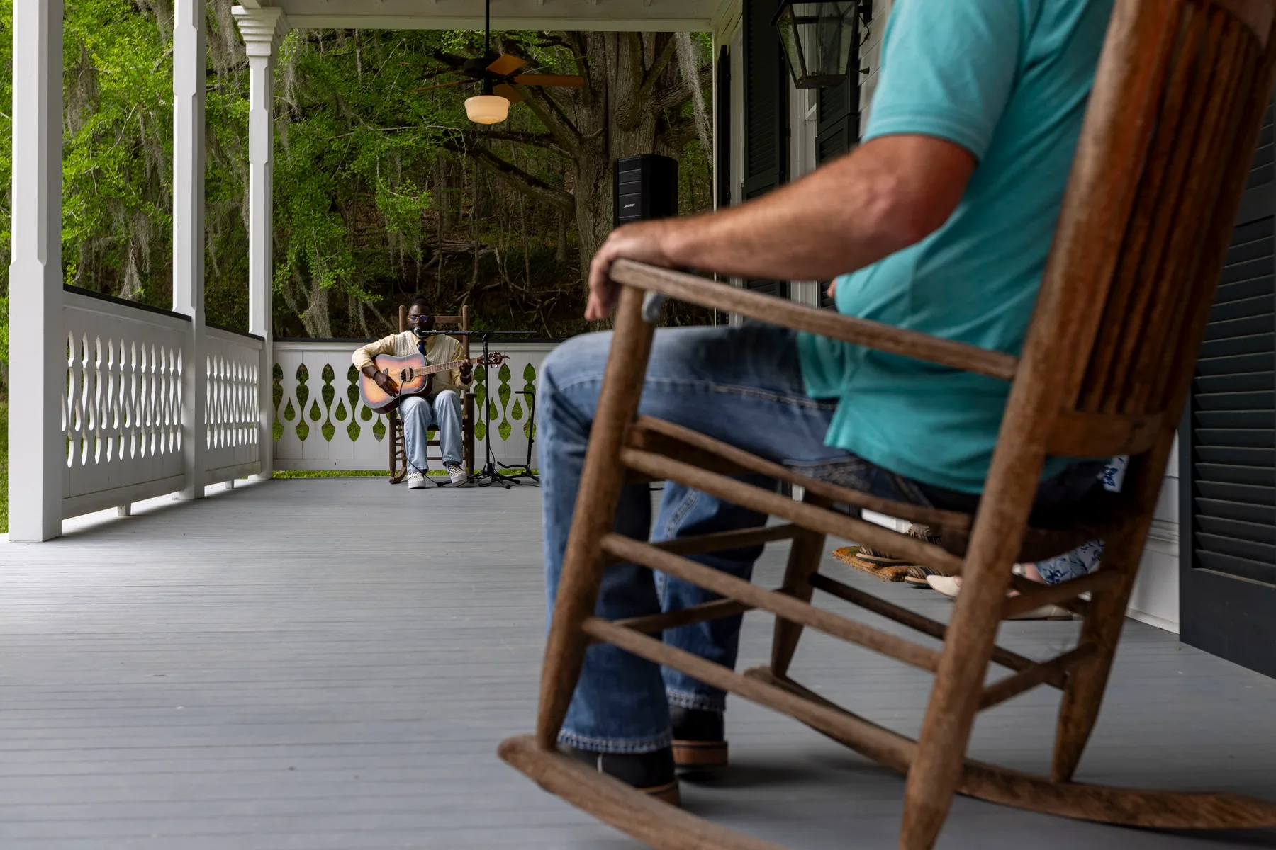 Rocking on the porch while a guitarist plays