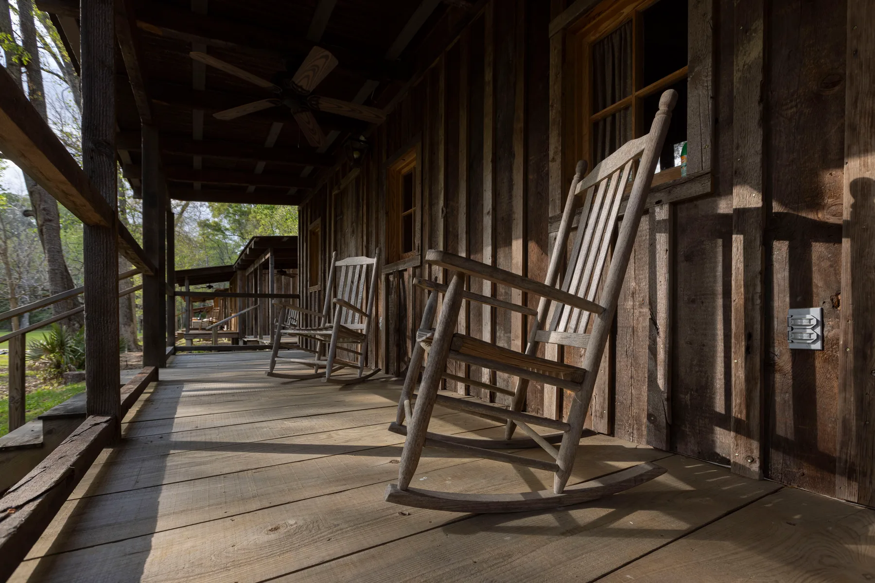 Rocking chairs lining a cabin porch