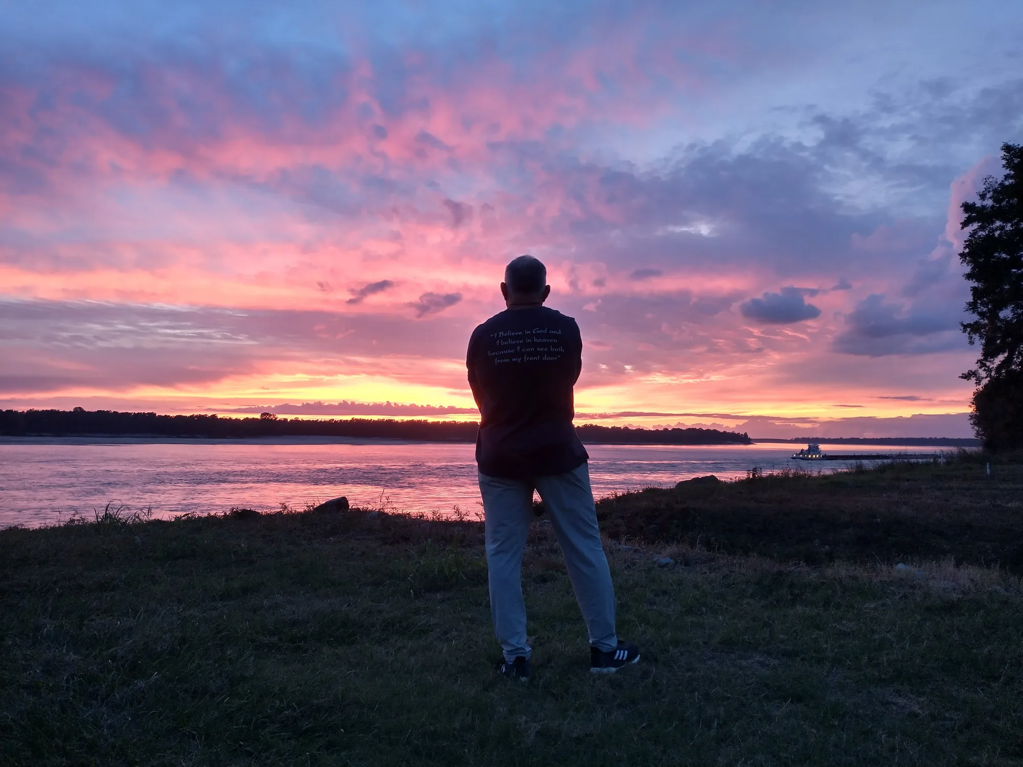 A figure watching the sunset over the Mississippi at Como
